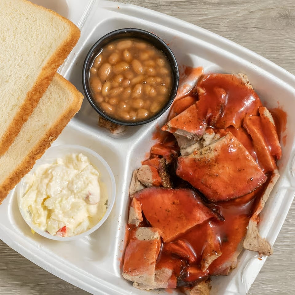 Ashley's Bar-B-Que sliced pork plate with baked beans, coleslaw, and white bread.